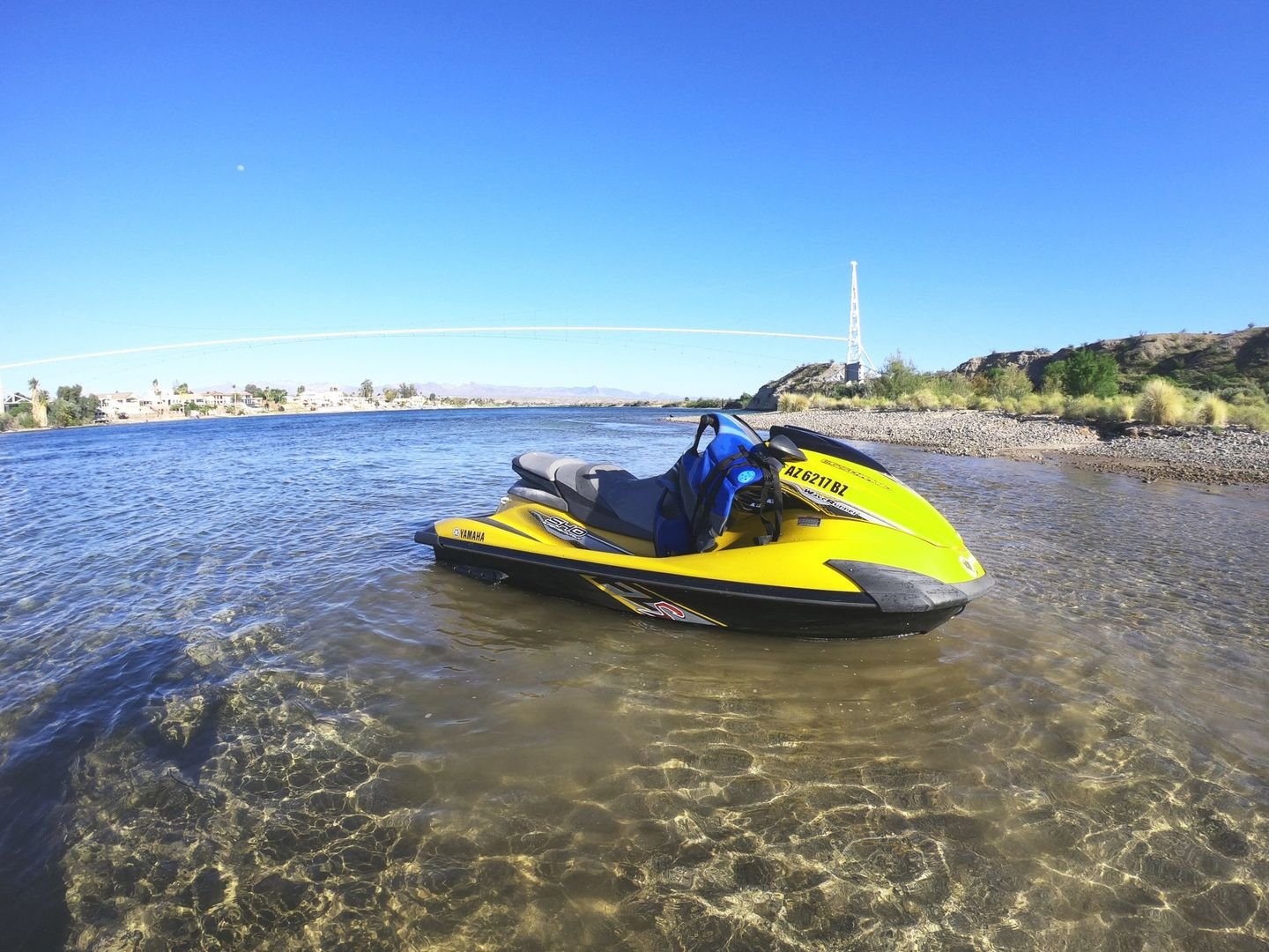 Yellow jet ski in clear shallow water near the shore